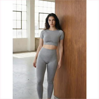 Gray athletic two-piece set made of stretchy fabric featuring bubble gum leggings for comfortable activewear