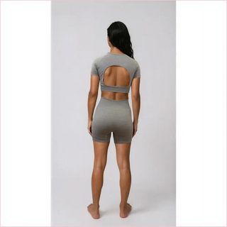 Gray seamless two-piece workout set with bubble gum top bra top and cutout back with high-waisted shorts